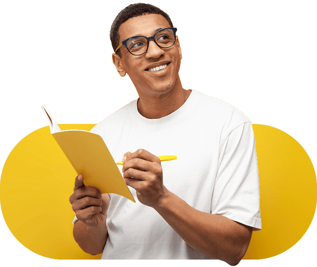 A smiling person holding a book.
