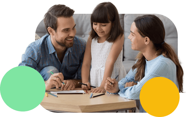 A mother and father happily teaching their child.