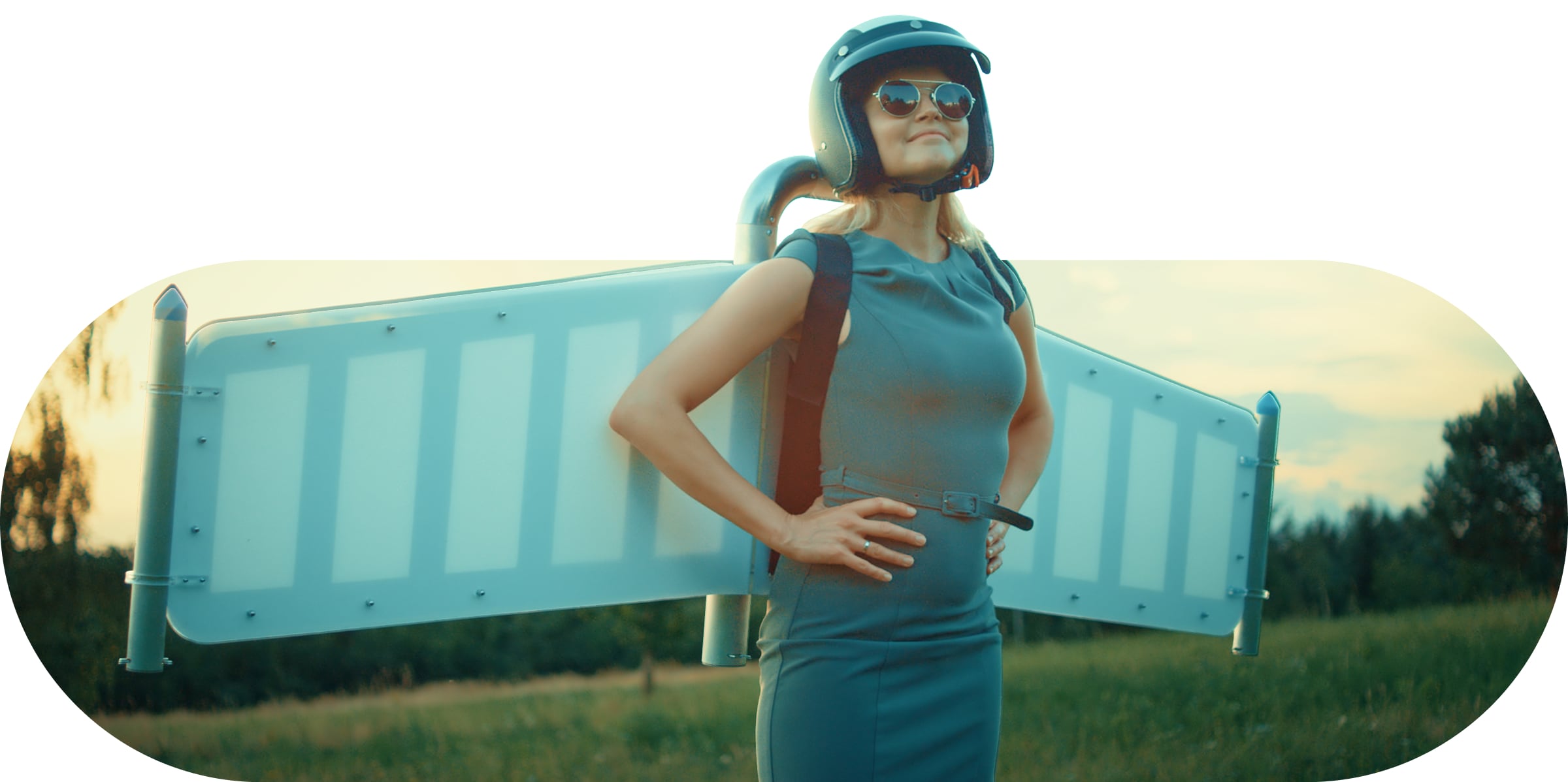 A woman with wings and a helmet in an open field.