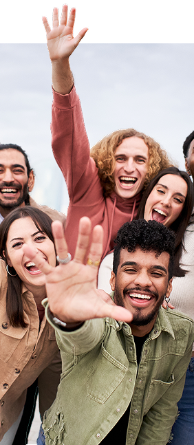 group of people smiling showing their hands