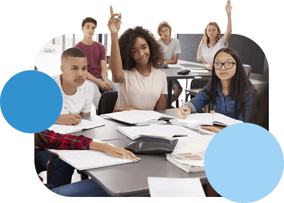 A group of students in class with some raising their hands.