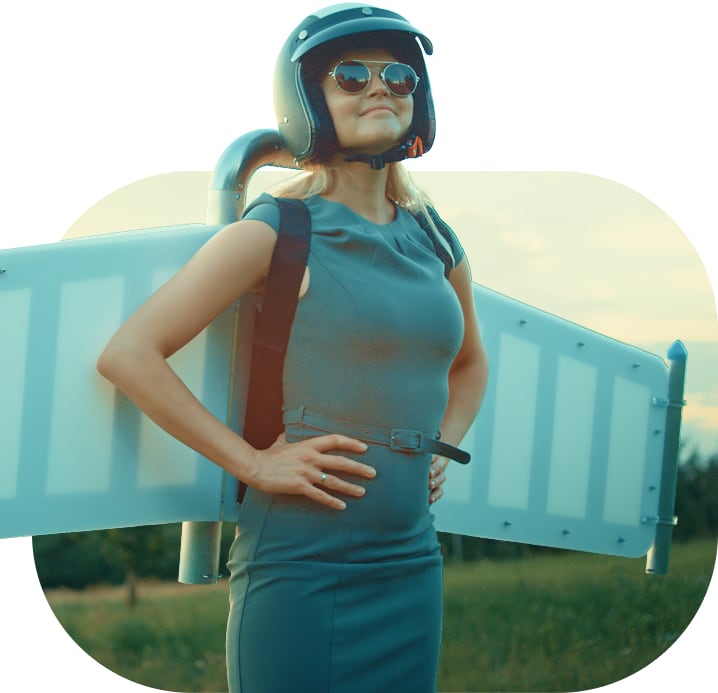 A woman with wings and a helmet in an open field.